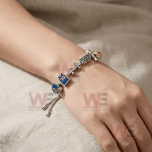 Silver adjustable charm bracelet worn on a wrist with Golden State Warriors logo jersey bridge text trophy and basketball charms.