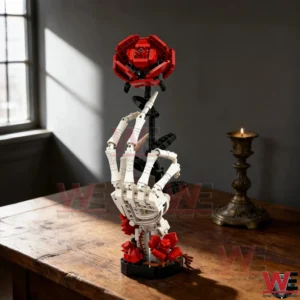 A skeleton hand brick sculpture holding a red rose standing on a wooden surface in a dark aesthetic room!