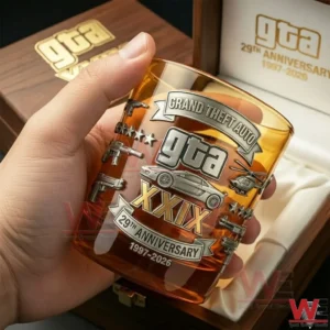 Hand holding engraved gaming themed whiskey glass near wooden gift box!