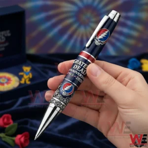 Hand holding a Grateful Dead commemorative pen with music themed decor and artistic background!
