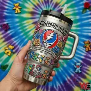 Hand holding a Grateful Dead anniversary tumbler with roses dancing bears and skull emblem against a colorful tie dye background!