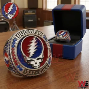 A close view of a decorative ring with a skull lightning design resting on a table with a ring box in the background!