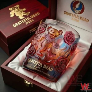 Close up view of a Grateful Dead commemorative whisky glass with a dancing bear and rose design placed inside a wooden gift box with soft lining!