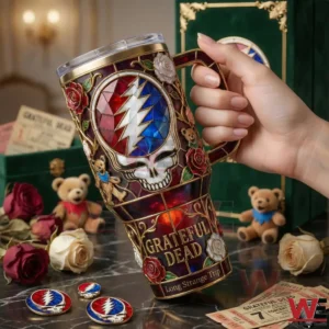 Hand holding a Grateful Dead tumbler with stained glass skull lightning and rose design!