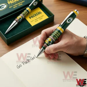 Hand writing with a Green Bay Packers green and gold anniversary pen with team logo and helmet design with the open gift box in the background!