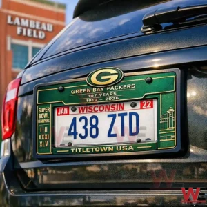 Rear view of a dark SUV with a Green Bay Packers themed license plate frame showing Wisconsin plate number 438 ZTD near Lambeau Field!
