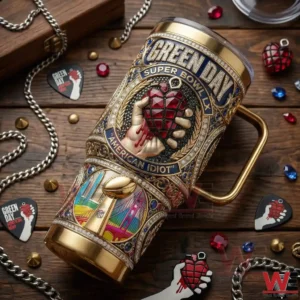 Green Day Super Bowl LX American Idiot tumbler resting on a wooden table with music themed items around it!