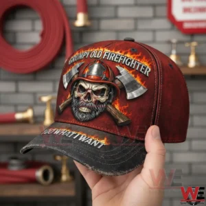 Hand holding a firefighter themed baseball cap with skull helmet crossed axes and flame graphics inside a fire station background!
