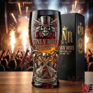 Guns N Roses anniversary whiskey glass featuring skull and guitar design displayed with concert lighting and energetic crowd scenery!