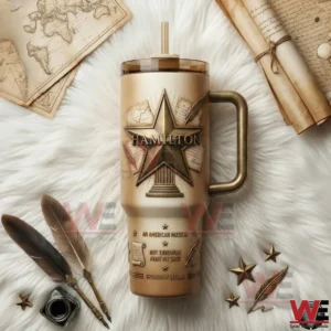 Hamilton Star 40oz Tumbler 5 Hamilton themed tumbler with gold star emblem handle lid and straw displayed on a white fur background with vintage accessories!