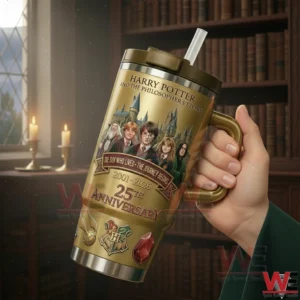 Hand holding a gold Harry Potter anniversary tumbler with a handle and straw featuring character artwork and 25th anniversary text in a library background!