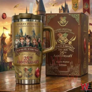 Gold Harry Potter 25th anniversary tumbler with handle and straw next to a collector edition box with a castle and sunset background!