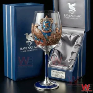 A Ravenclaw themed wine glass with blue stem and detailed eagle crest is displayed beside an open luxury gift box with satin lining!