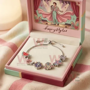 Gift boxed adjustable charm bracelet with Harry Styles themed charms including watermelon heart microphone jacket star and text charm inside a pastel presentation box.