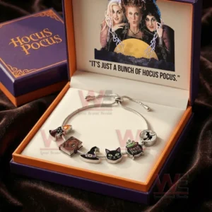 Silver adjustable charm bracelet in a purple and orange gift box with Hocus Pocus artwork and charms including witch hat black cat spell book cauldron and flying witch!