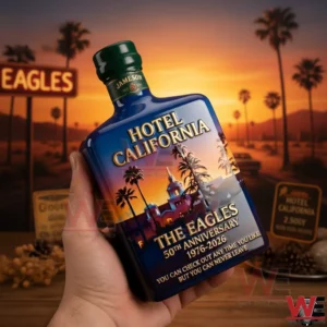 A Hotel California themed whiskey bottle held in front of a sunset landscape with palm trees and nostalgic scenery!