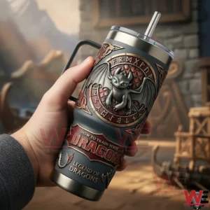 How to Train Your Dragon Toothless Tumbler 3 Hand holding a dark dragon themed insulated tumbler with a rune emblem and straw against a warm fantasy inspired background!