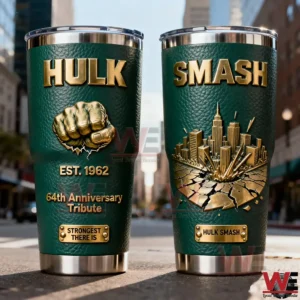 Two Hulk insulated tumblers with green textured exterior gold lettering anniversary tribute fist emblem and a three dimensional smash city design displayed on a city street!