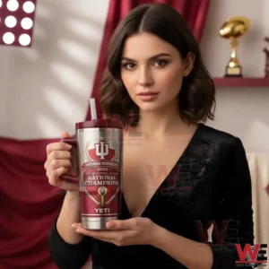 A woman holding an Indiana Hoosiers 2026 national champions tumbler with team colors and championship graphics displayed clearly!