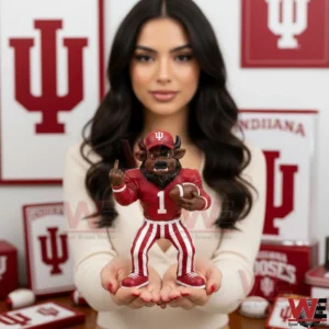 Indiana Hoosiers Mascot Middle Finger Figurine 3 An Indiana Hoosiers mascot figurine is held in both hands against a backdrop filled with team logos and decor!