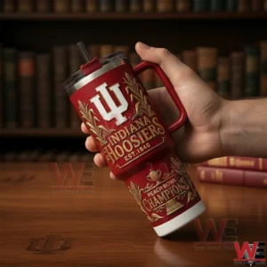 Hand holding a red Indiana Hoosiers tumbler with gold detailing in front of a bookshelf background!