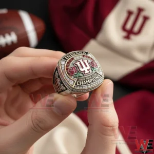 Indiana Hoosiers Rose Bowl 2026 Championship Custom Ring 6 Alt text Hands holding a silver Indiana 2026 Rose Bowl Champions ring with IU logo while a football and Indiana apparel appear in the background.