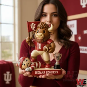 Woman holding a team mascot victory figurine with a football themed background!