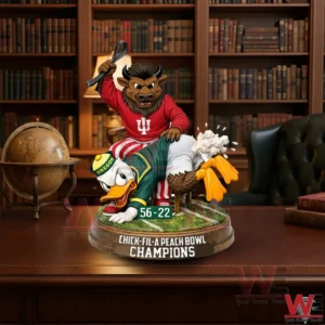 A bull mascot in red sits on a chair raising a strap while pressing a duck mascot onto a grass platform inside a classic library setting!