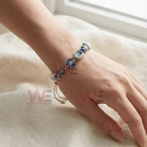 Adjustable charm bracelet on a wrist with Indianapolis Colts themed charms including helmet horseshoe number eighteen jersey stadium football and For The Shoe sign.