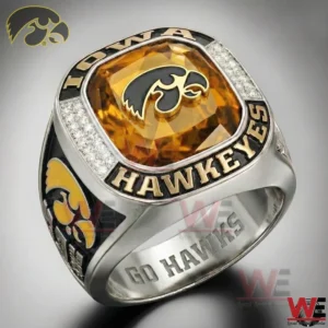 Silver Iowa Hawkeyes ring with a large golden gemstone and hawk logo on the face surrounded by sparkling stones and team lettering.