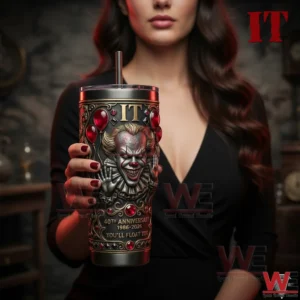 A female model holding a dark horror themed insulated tumbler with a sculpted clown face red balloon details and metallic finish in a cinematic environment!
