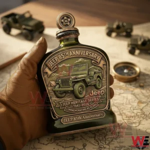 A person holding a Jeep anniversary whiskey bottle with classic vehicle artwork placed above a map and surrounded by adventure themed objects!