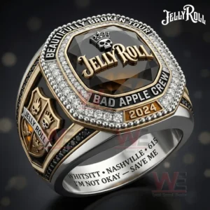 Gold and silver championship ring with a dark faceted gemstone face showing Jelly Roll lettering a crowned skull icon and surrounding text Beautifully Broken Tour Bad Apple Crew and 2024.