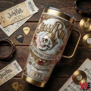 A Jelly Roll insulated tumbler placed on a wooden table with concert tickets records and music accessories!