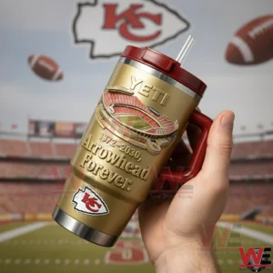 Hand holding a gold Kansas City Chiefs insulated travel mug with red lid handle and straw featuring Arrowhead Forever text and a stadium illustration with a football stadium background!