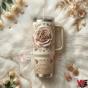 Lana Del Rey themed tumbler with handle and straw featuring a large rose design placed on white fur with floral and elegant decor!