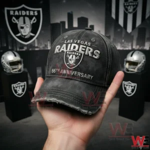Las Vegas Raiders 66th Anniversary Balck Cap Hat 3 Hand holding a Las Vegas Raiders black cap with sixty six anniversary logo in a Raiders themed setting!