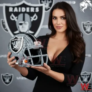 A woman wearing a black outfit holds a gray Las Vegas Raiders football helmet constructed from building blocks with the team logo clearly visible in the background!