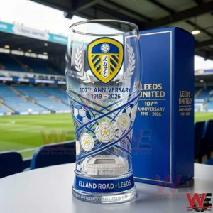 A tall clear glass with Leeds United crest anniversary design placed inside a football stadium environment!