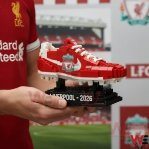 This image presents a collectible Liverpool football boot building block model highlighted by bold red tones club crest details and a commemorative display stand!