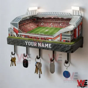 A Liverpool stadium wall key holder with realistic stands green pitch and several keys hanging neatly underneath!