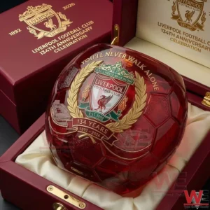 A red crystal football glass with Liverpool Football Club crest and 134 year anniversary design resting inside a luxurious presentation box with club branding!