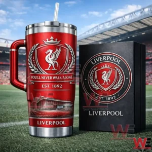 Red Liverpool football club insulated tumbler with handle and straw next to a collector style box on a football field with stadium stands behind!