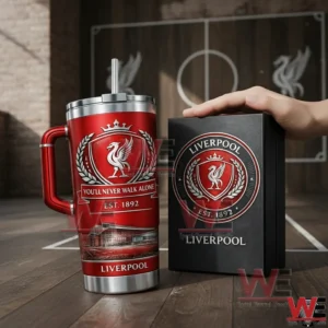 Liverpool You'll Never Walk Alone 1892-2026 Anniversary Tumbler Cup 3 Red Liverpool football club insulated tumbler with handle and straw next to a collector style box in an indoor setting with a football pitch background!