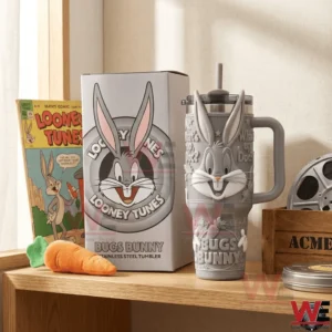 Bugs Bunny themed tumbler with handle and straw displayed beside a matching box on a shelf with classic decor!