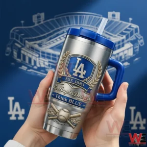 Hands holding a silver Los Angeles Dodgers tumbler with blue handle and straw showing LA shield laurel wreath est 1883 think blue text and baseball with crossed bats artwork