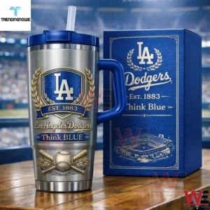 Silver Los Angeles Dodgers tumbler with blue handle and straw next to a matching gift box featuring LA monogram laurel wreath est 1883 think blue text and stadium illustration