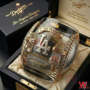A detailed Los Angeles Dodgers anniversary whiskey glass with gold etched graphics baseball stitching elements and a luxury collectors box background!