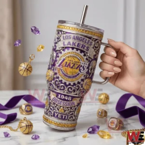Handheld view of a purple and gold insulated tumbler with ornate Los Angeles Lakers artwork and decorative elements!