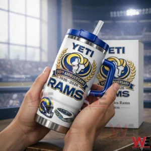 Hands holding a white Los Angeles Rams anniversary insulated travel mug with blue lid handle and straw with a matching white box and a blurred stadium background!